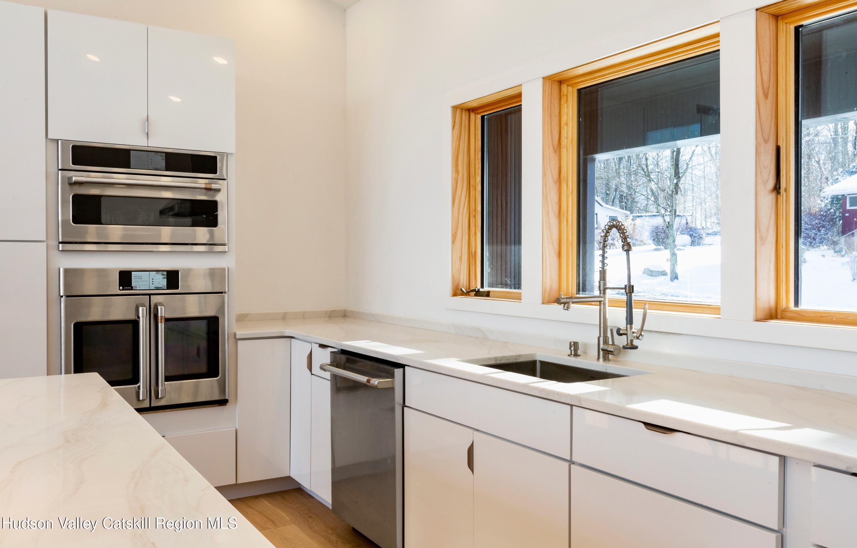 513 Myrtle Avenue Wallkill, NY 12589 - Photo 16 of 62 a kitchen with stainless steel appliances a stove and a sink