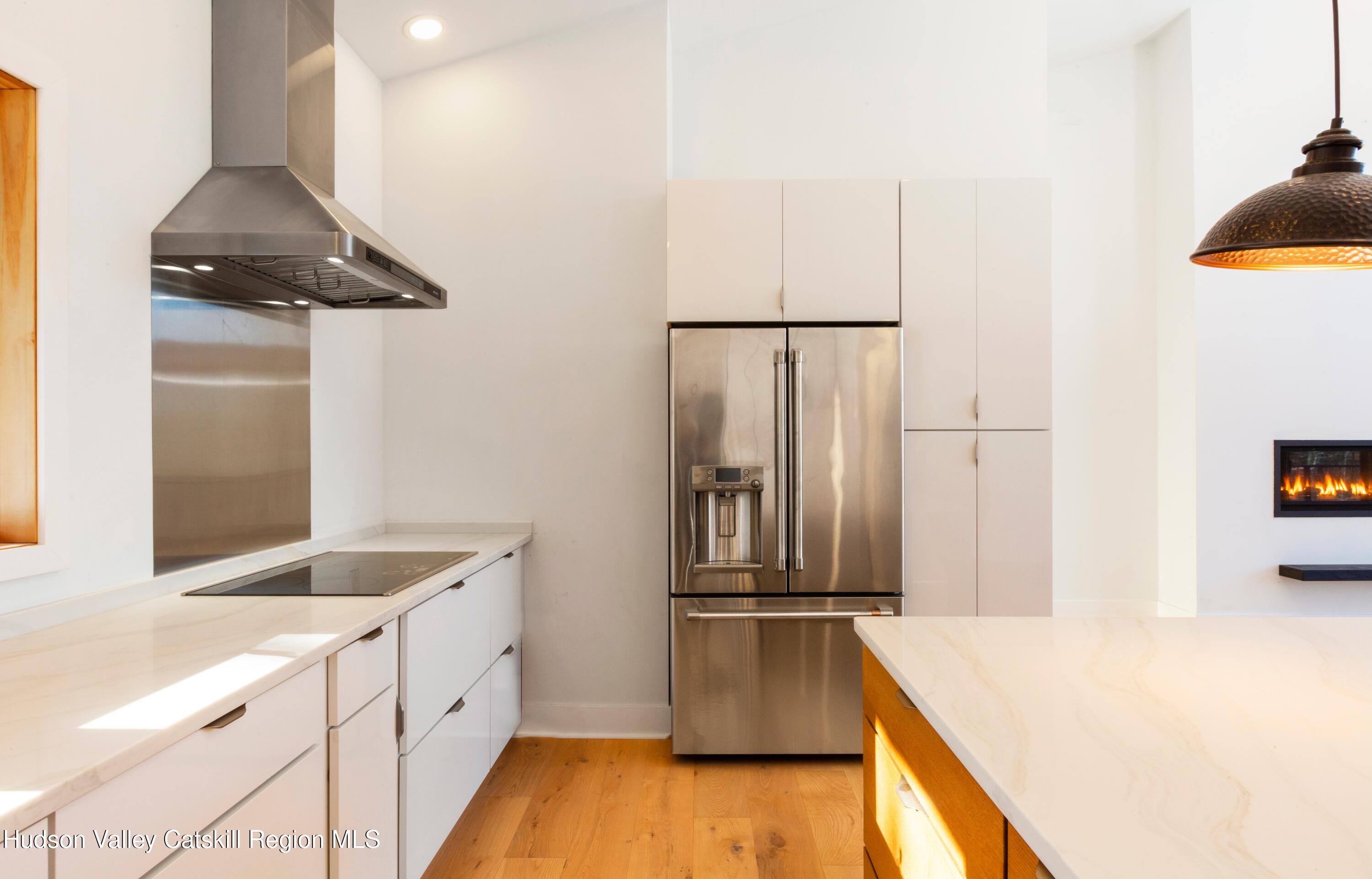 513 Myrtle Avenue Wallkill, NY 12589 - Photo 19 of 62 a kitchen with granite countertop a refrigerator a sink and wooden floor