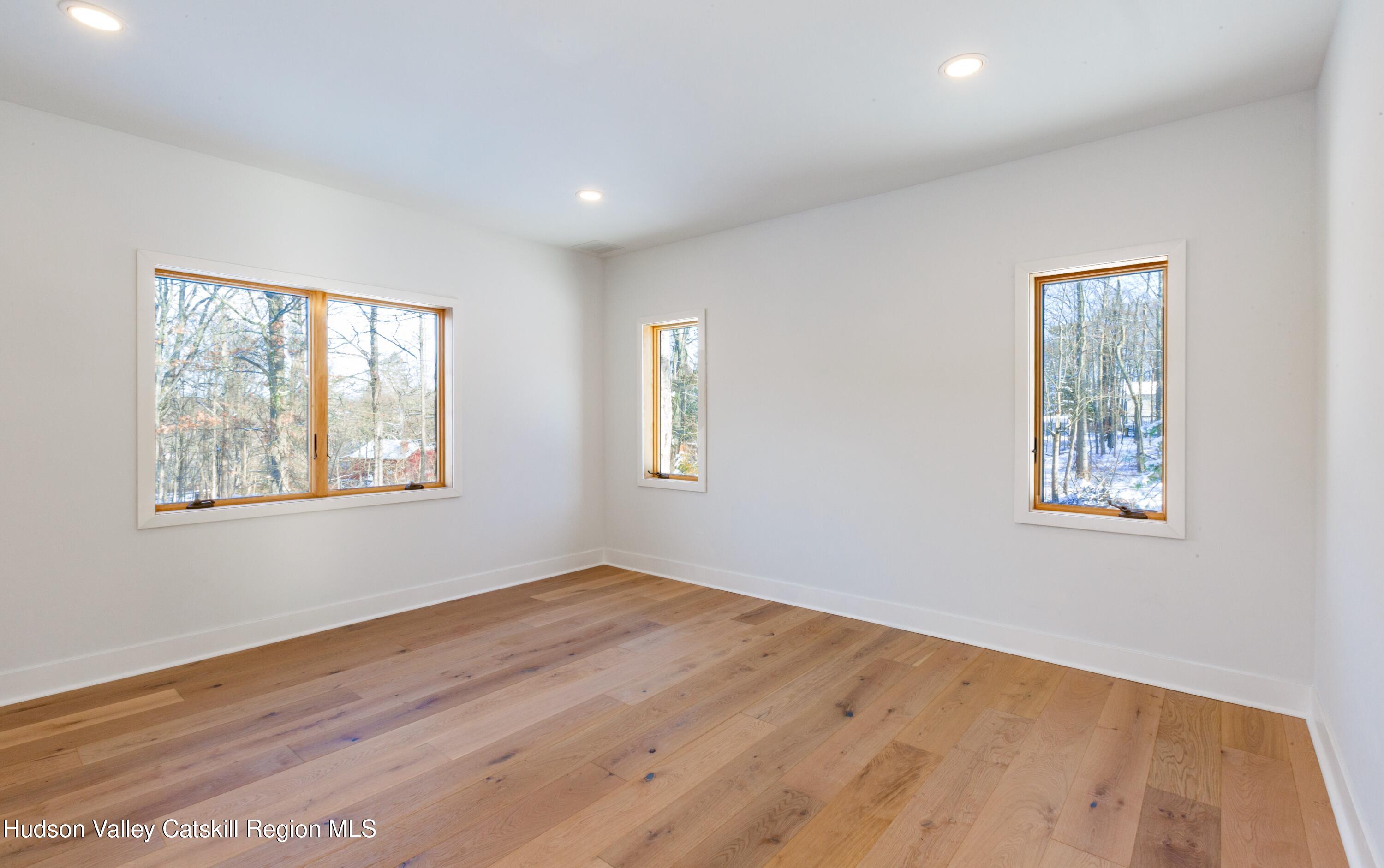 513 Myrtle Avenue Wallkill, NY 12589 - Photo 27 of 62 a view of an empty room with wooden floor and a window