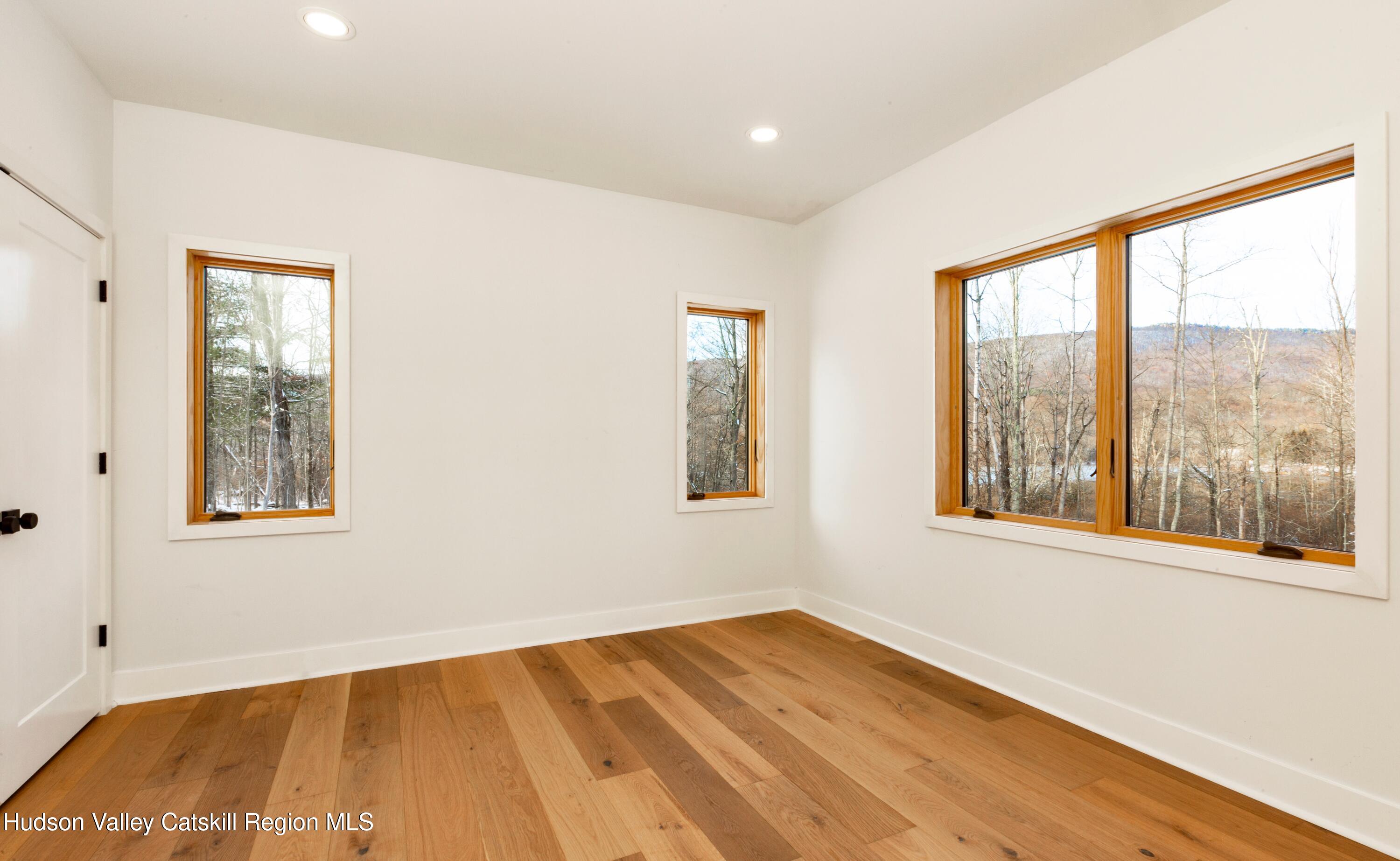 513 Myrtle Avenue Wallkill, NY 12589 - Photo 28 of 62 a view of an empty room with wooden floor and a window