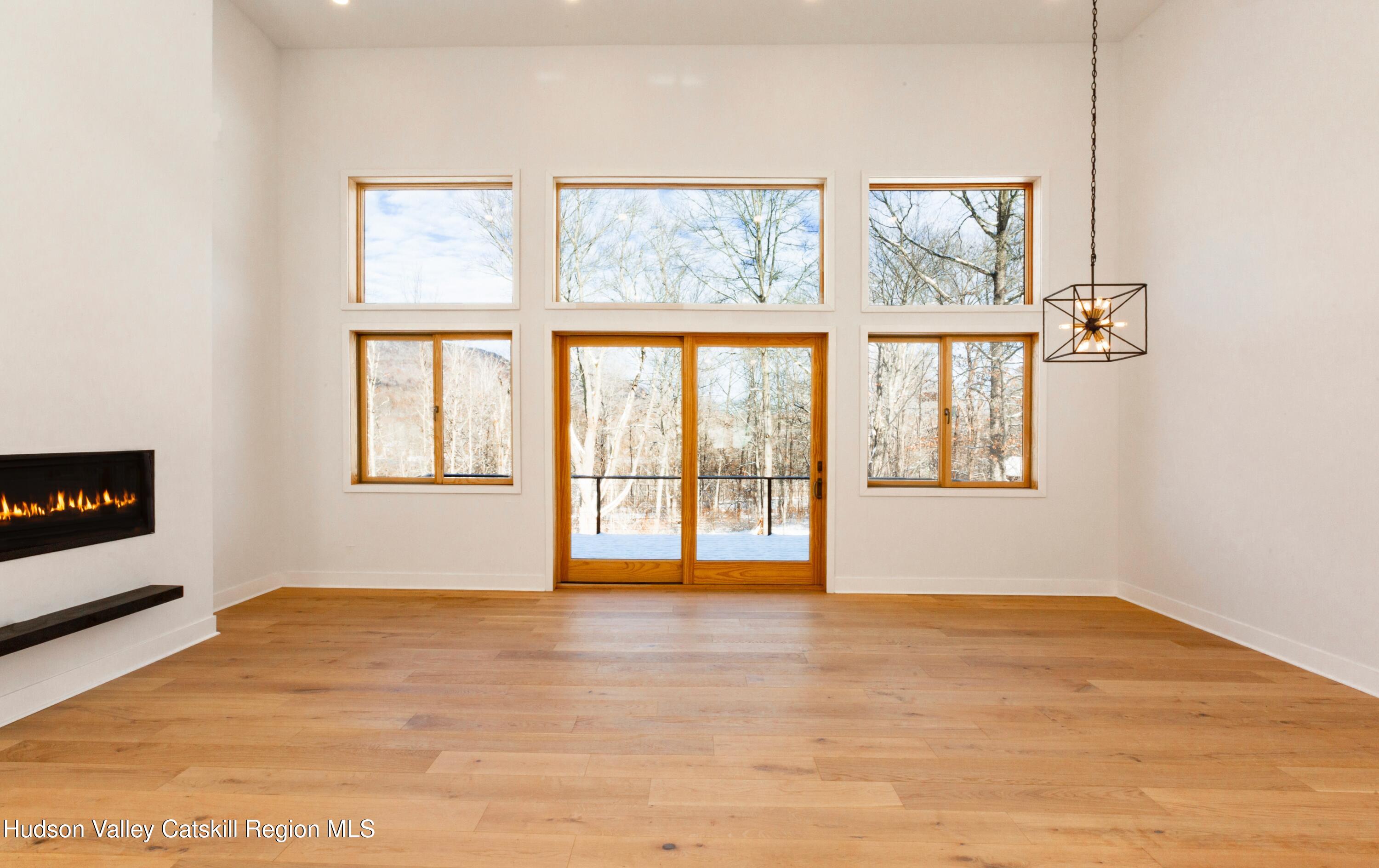 513 Myrtle Avenue Wallkill, NY 12589 - Photo 3 of 62 a view of an empty room with a window and wooden floor