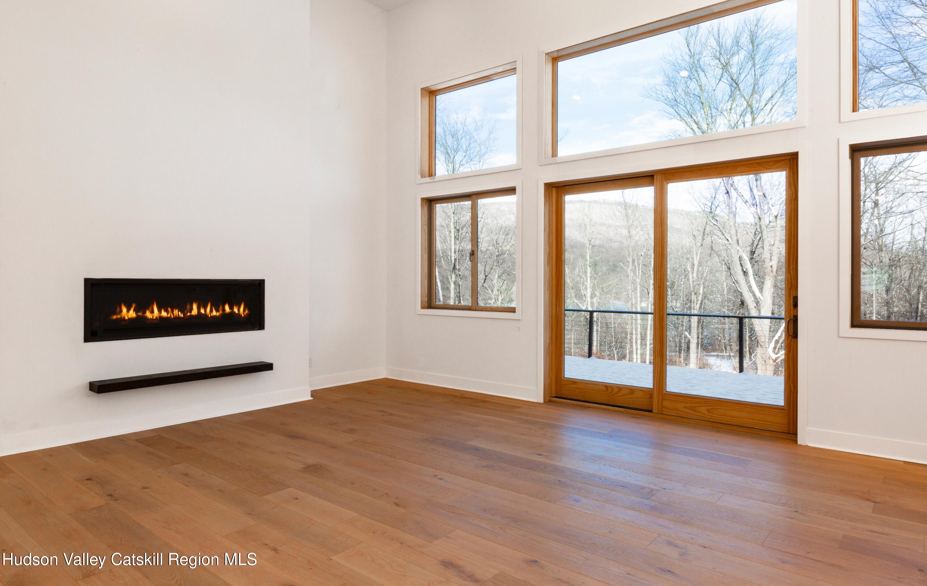513 Myrtle Avenue Wallkill, NY 12589 - Photo 9 of 62 a view of an empty room with wooden floor and a window