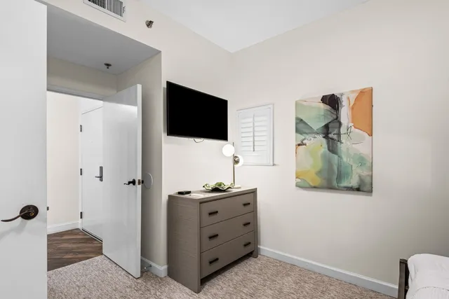 a view of a backyard with couches under an umbrella