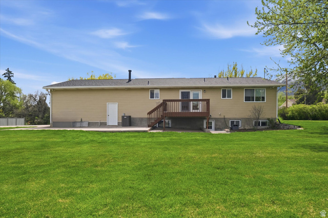 45 West 100 South Mendon, UT 84325 - Photo 41 of 64 Back of house with a patio, a yard, and a wooden deck