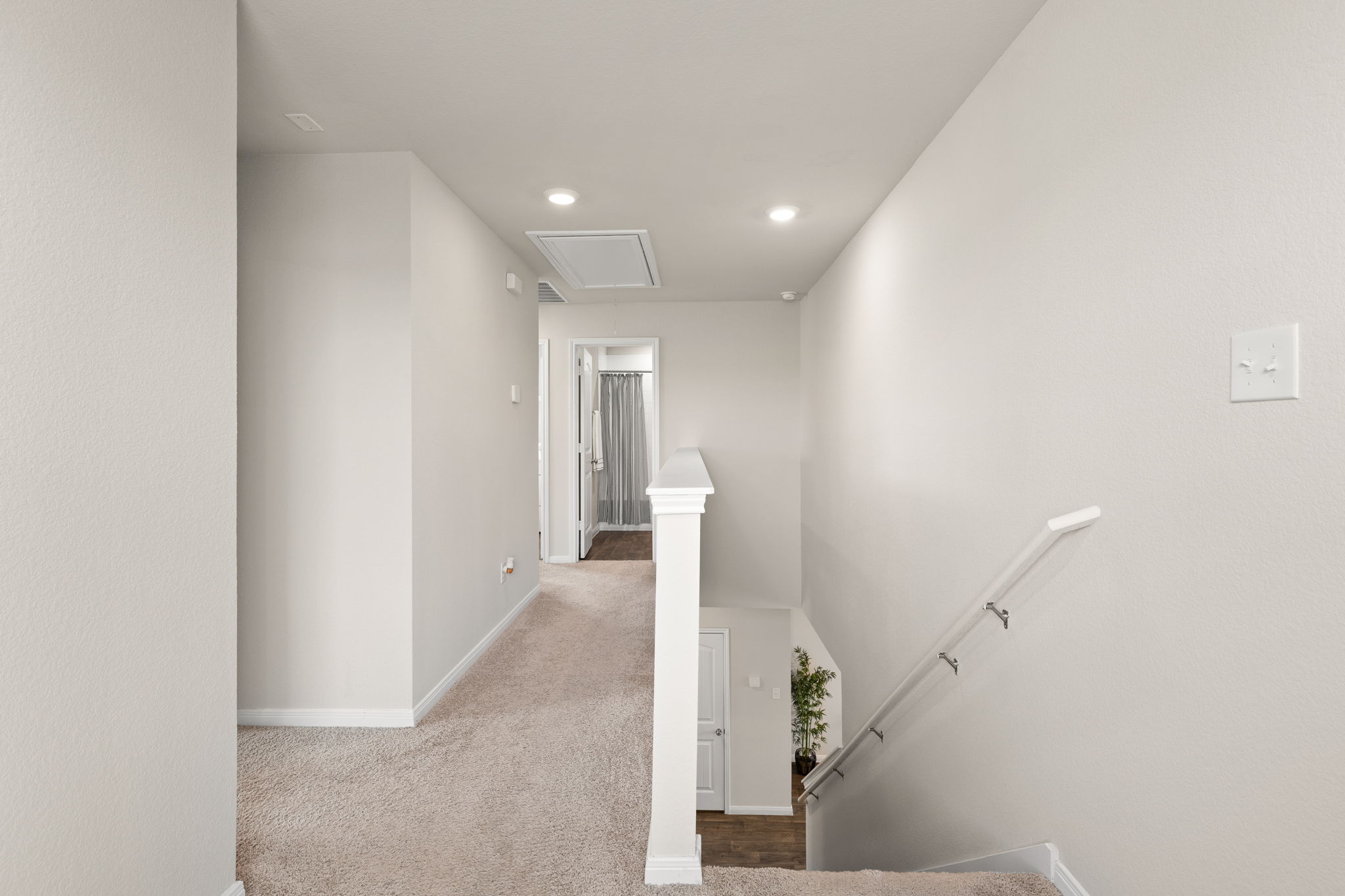 281 Jayden Drive Kyle, TX 78640 - Photo 19 of 36 Carpeted hallway with white baseboards and light neutral wall paint