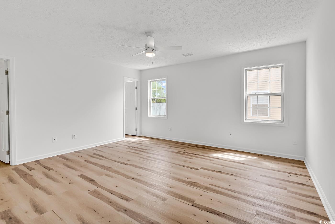 9616 Sullivan Drive Murrells Inlet, SC 29576 - Photo 13 of 23 Empty room featuring ceiling fan, a textured ceili