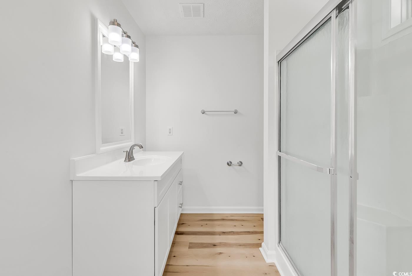 9616 Sullivan Drive Murrells Inlet, SC 29576 - Photo 17 of 23 Full bath featuring vanity, baseboards, wood finis
