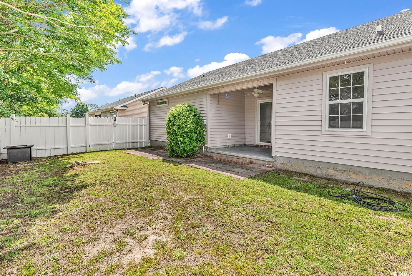 9616 Sullivan Drive Murrells Inlet, SC 29576 - Photo 23 of 23 View of yard featuring fence, a ceiling fan, a pat