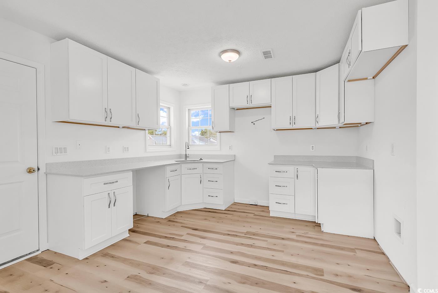 9616 Sullivan Drive Murrells Inlet, SC 29576 - Photo 4 of 23 Kitchen featuring white cabinets, light countertop