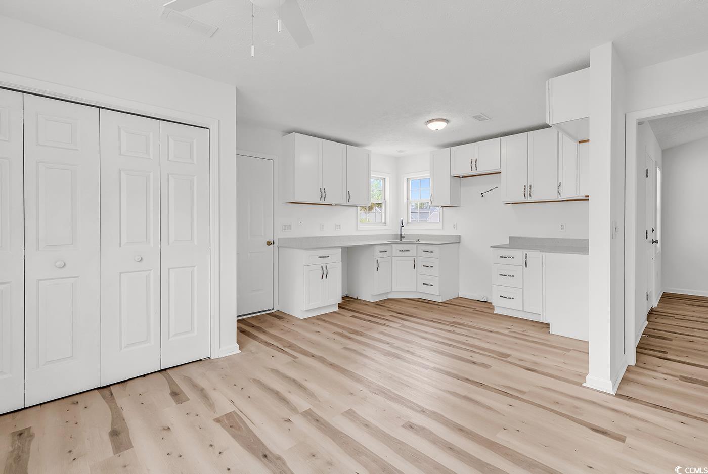 9616 Sullivan Drive Murrells Inlet, SC 29576 - Photo 5 of 23 Kitchen featuring white cabinetry, a ceiling fan,