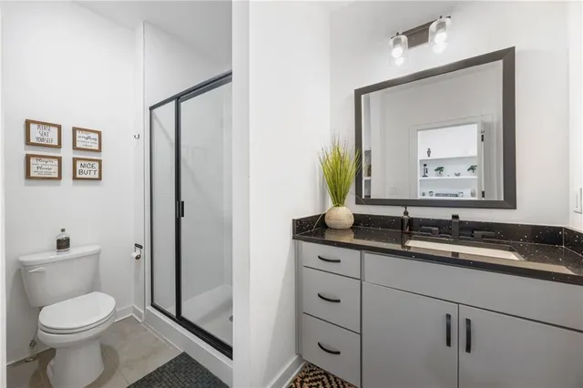 a bedroom with a bed window and wooden floor
