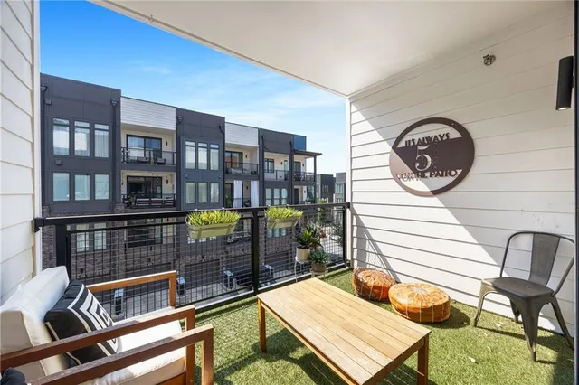 a view of a dining room with furniture and a floor to ceiling window