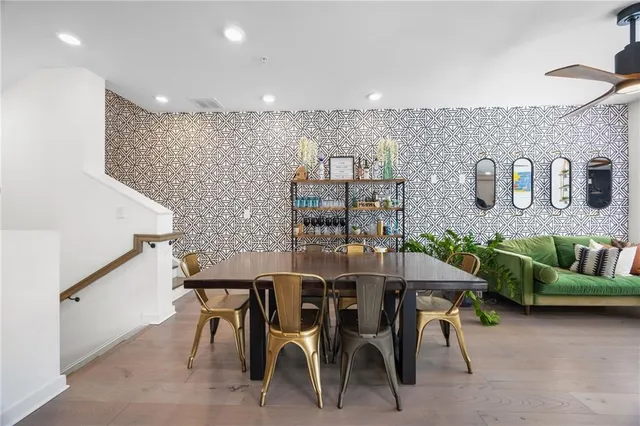 a dining room with furniture and wooden floor