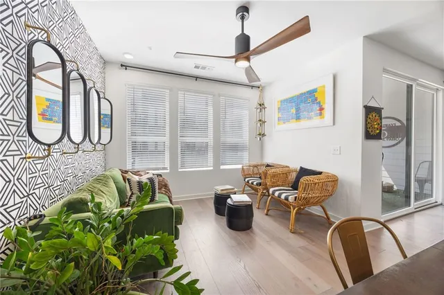 a kitchen with stainless steel appliances granite countertop a refrigerator a sink a stove a dining table and chairs