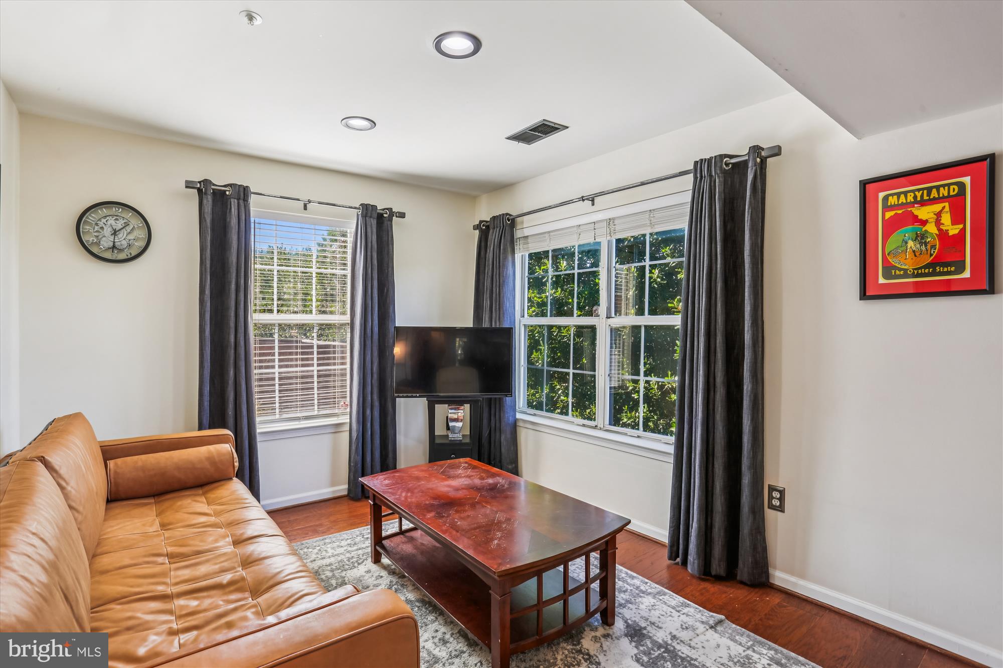 302 Ridgepoint Place, Unit 16 Gaithersburg, MD 20878 - Photo 11 of 40 a living room with furniture a window and a flat screen tv