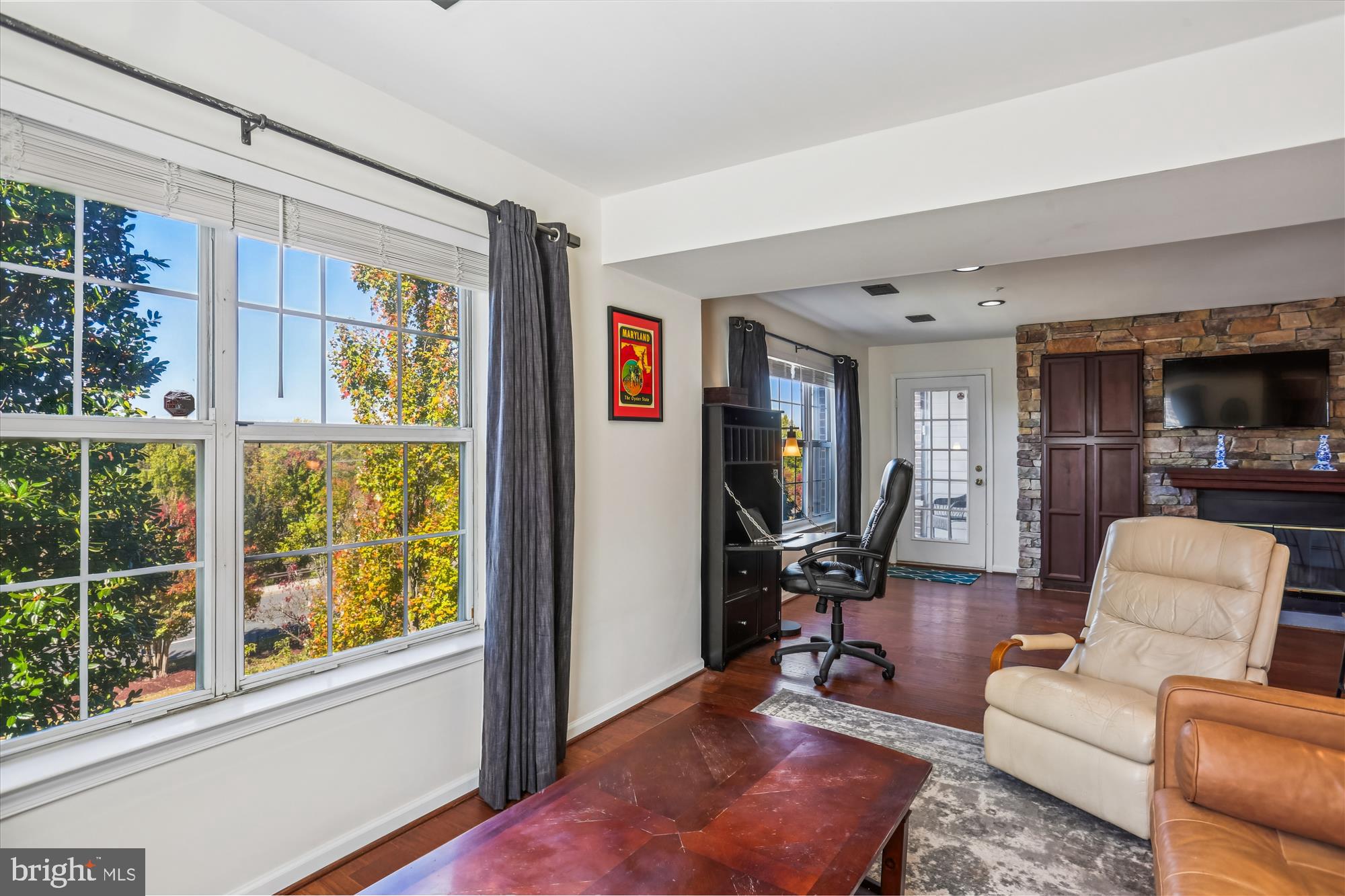 302 Ridgepoint Place, Unit 16 Gaithersburg, MD 20878 - Photo 12 of 40 a living room with furniture and a flat screen tv