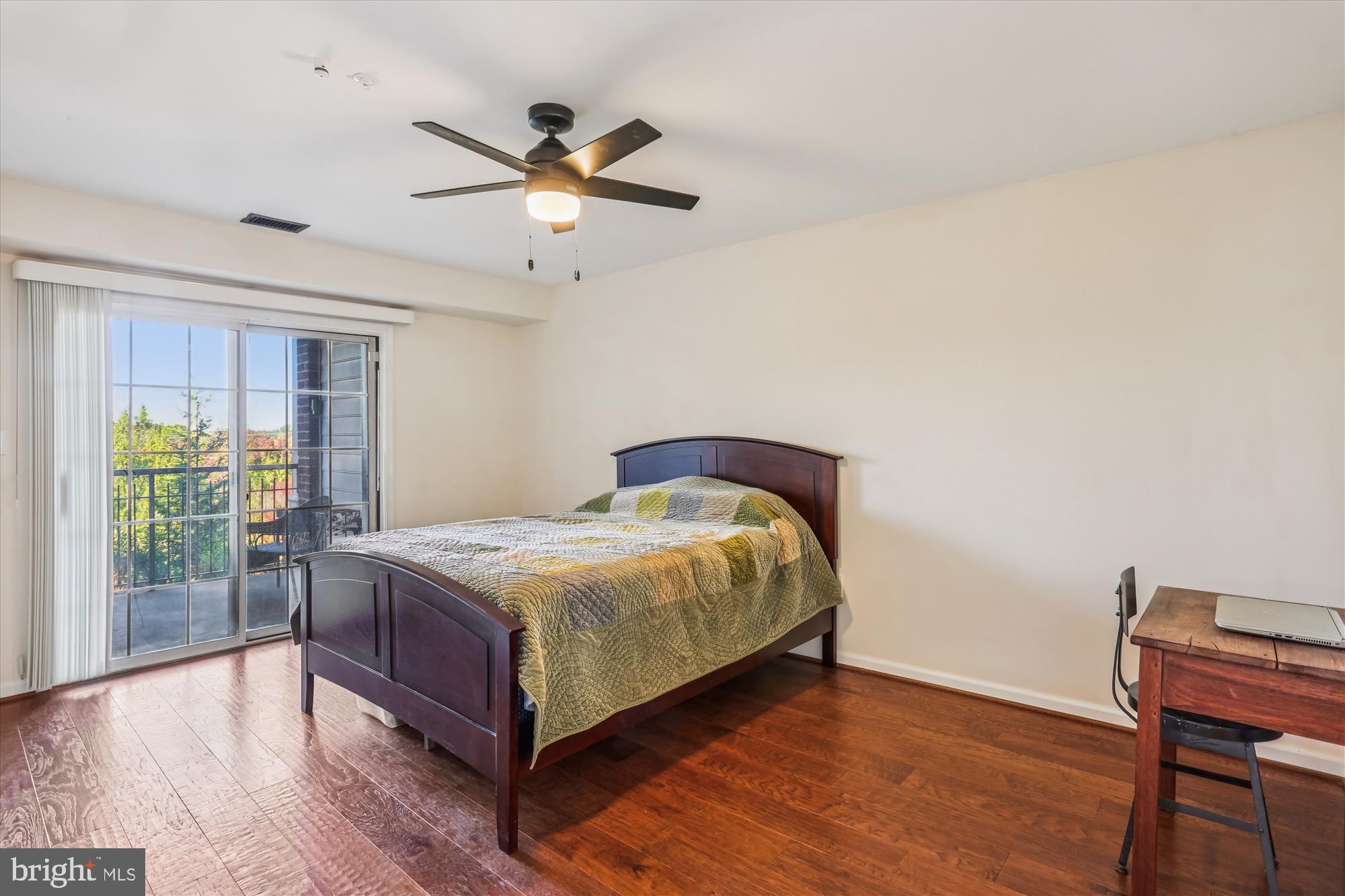 302 Ridgepoint Place, Unit 16 Gaithersburg, MD 20878 - Photo 14 of 40 a bedroom with a bed and wooden floor