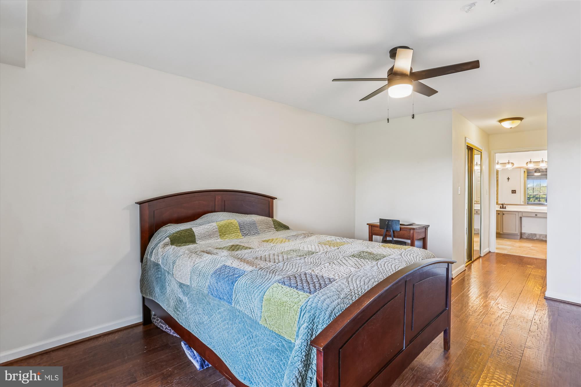 302 Ridgepoint Place, Unit 16 Gaithersburg, MD 20878 - Photo 16 of 40 a bedroom with a bed and wooden floor