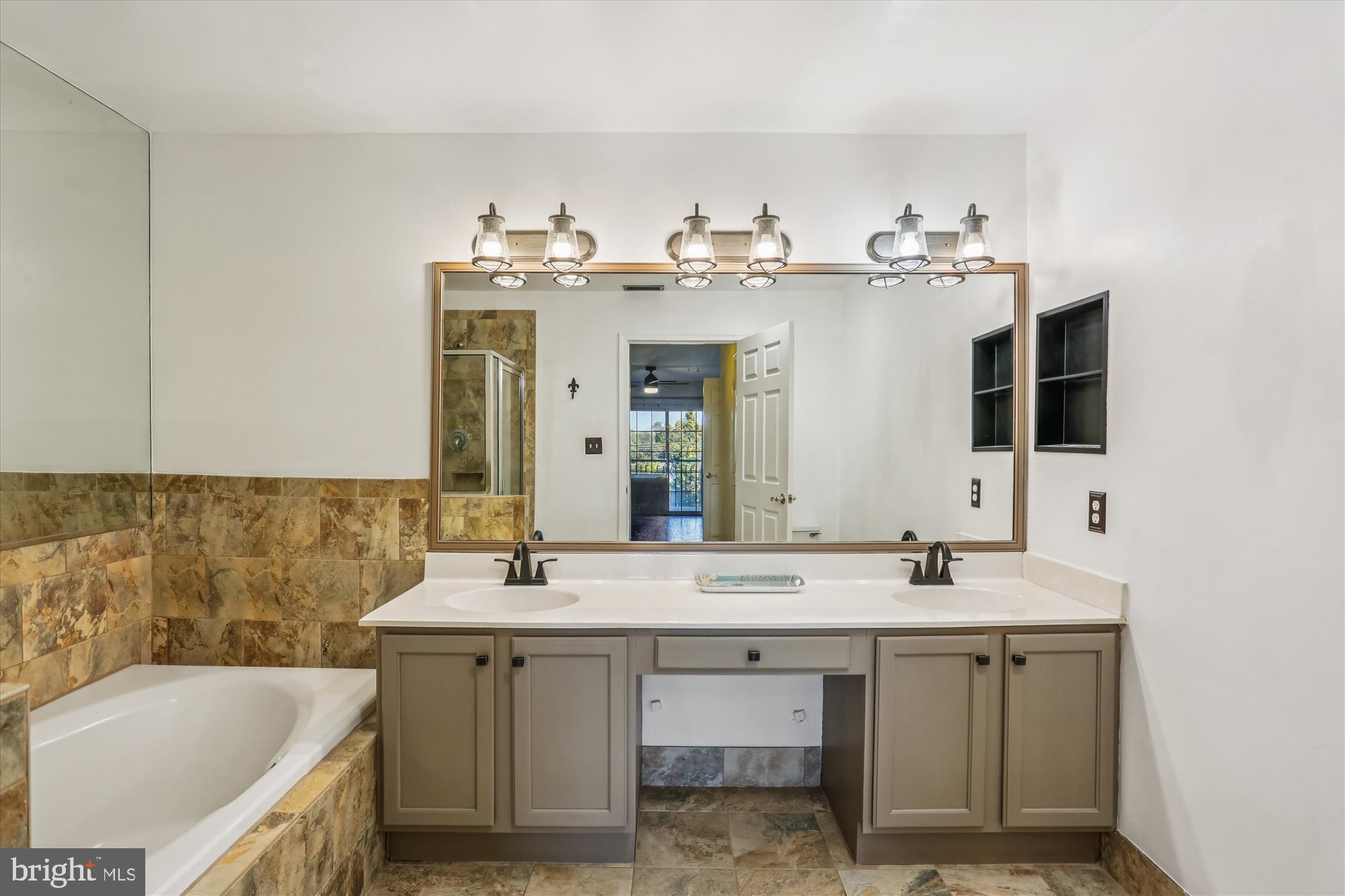 302 Ridgepoint Place, Unit 16 Gaithersburg, MD 20878 - Photo 17 of 40 a bathroom with a double vanity sink mirror and bathtub