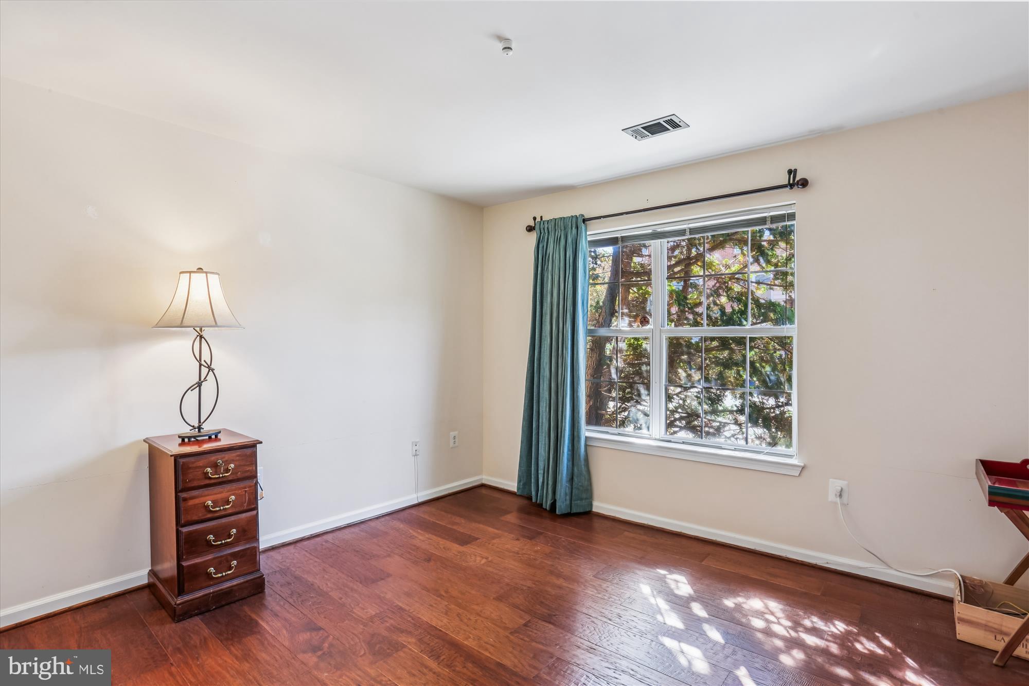 302 Ridgepoint Place, Unit 16 Gaithersburg, MD 20878 - Photo 19 of 40 a view of an empty room with window and wooden floor
