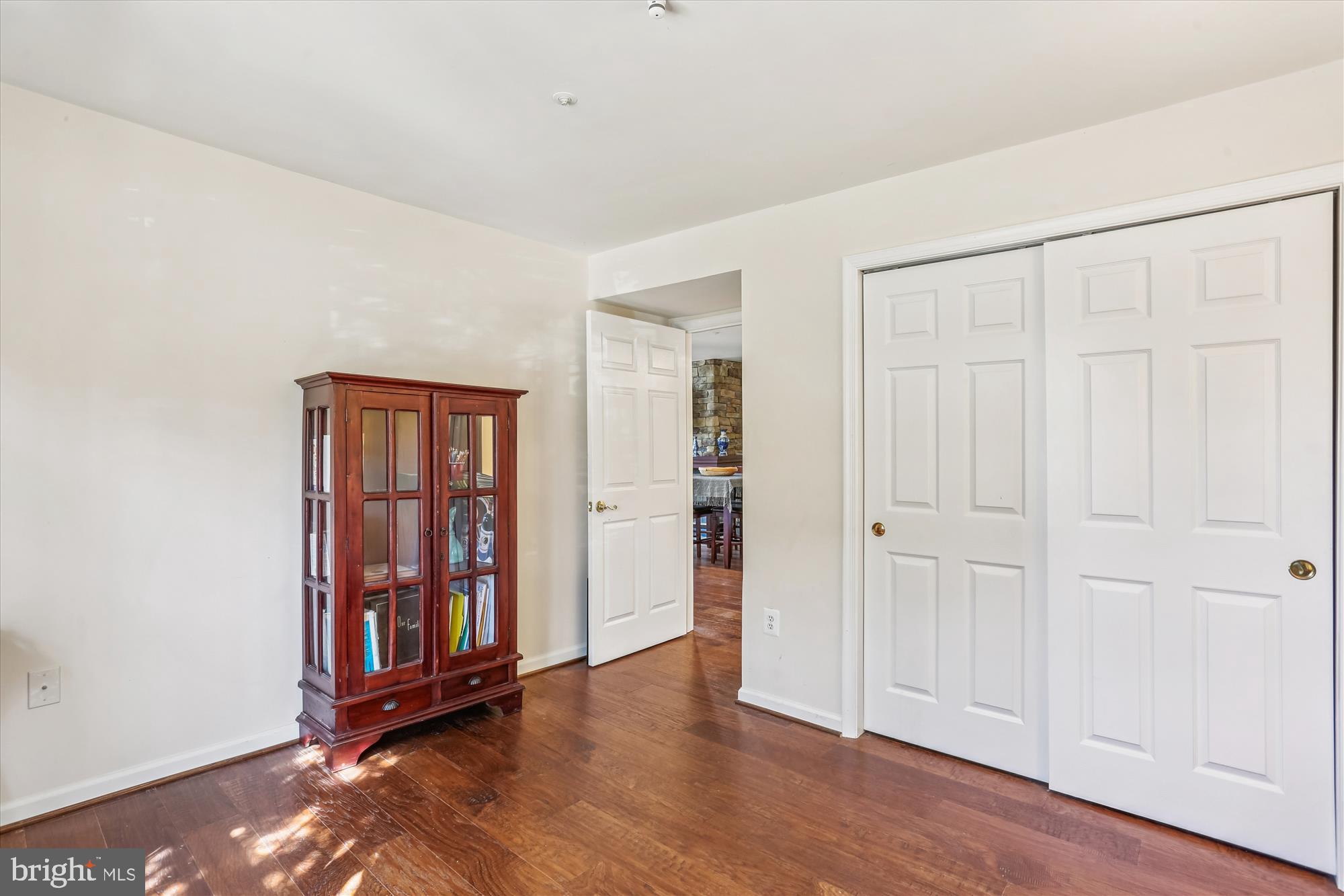 302 Ridgepoint Place, Unit 16 Gaithersburg, MD 20878 - Photo 20 of 40 an empty room with wooden floor closet and windows