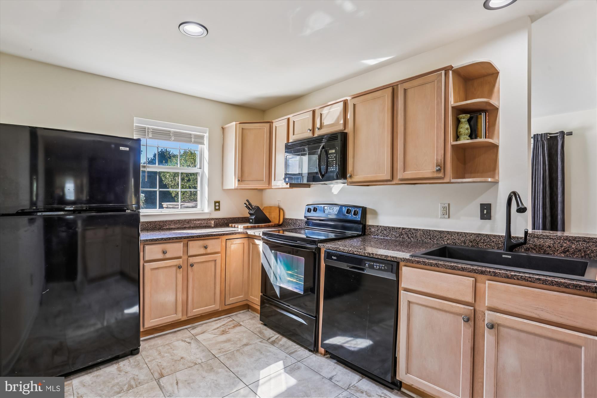 302 Ridgepoint Place, Unit 16 Gaithersburg, MD 20878 - Photo 6 of 40 a kitchen with granite countertop a sink stainless steel appliances and cabinets