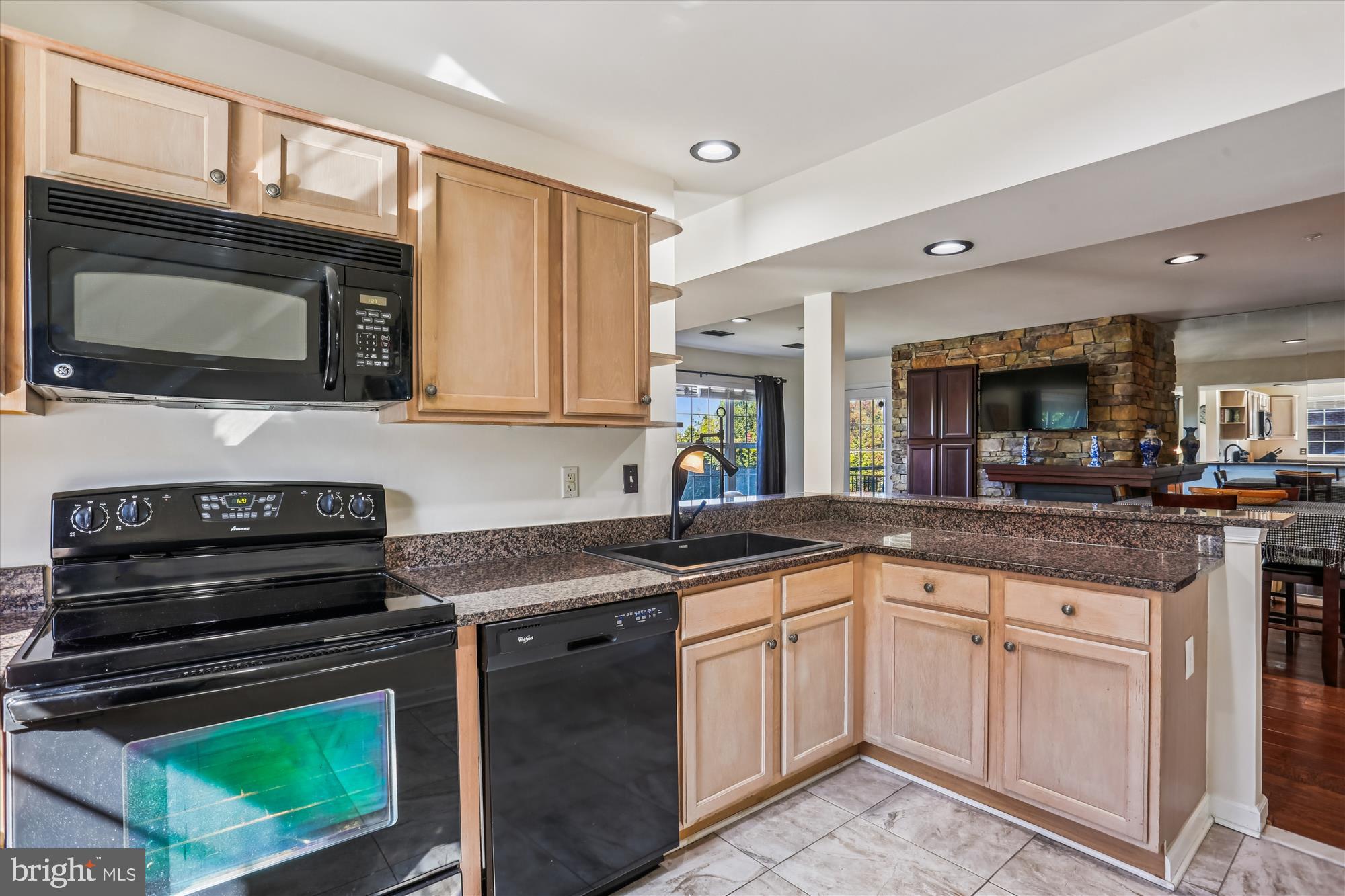 302 Ridgepoint Place, Unit 16 Gaithersburg, MD 20878 - Photo 8 of 40 a kitchen with stainless steel appliances granite countertop a stove microwave and sink