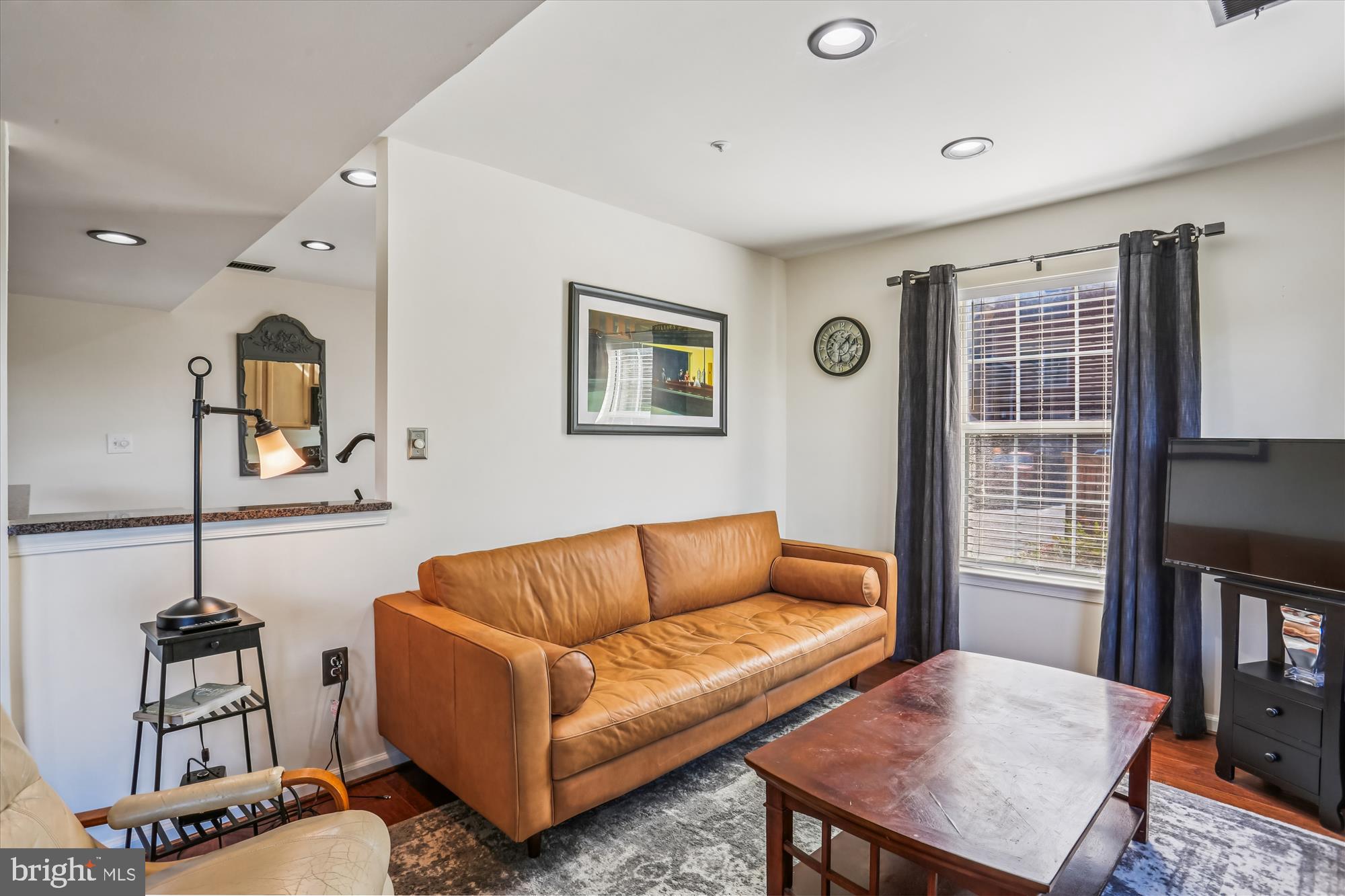 302 Ridgepoint Place, Unit 16 Gaithersburg, MD 20878 - Photo 10 of 40 a living room with furniture a flat screen tv and a window