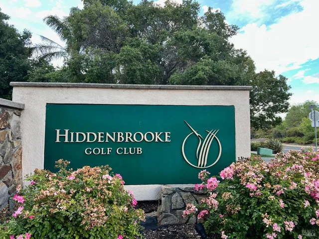 a sign that is sitting in front of flowers