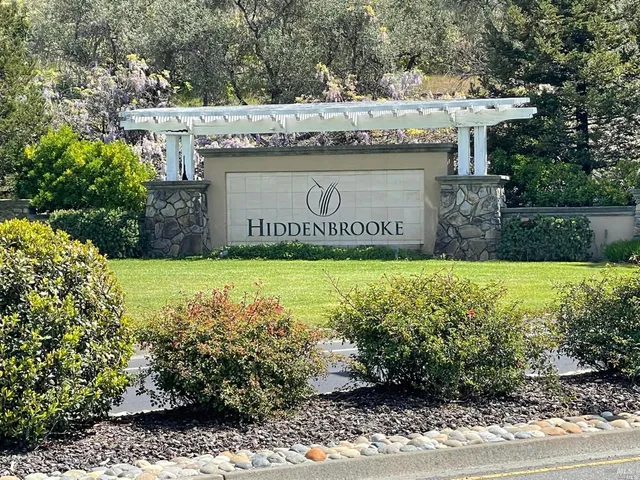 a view of outdoor space with garden and signage