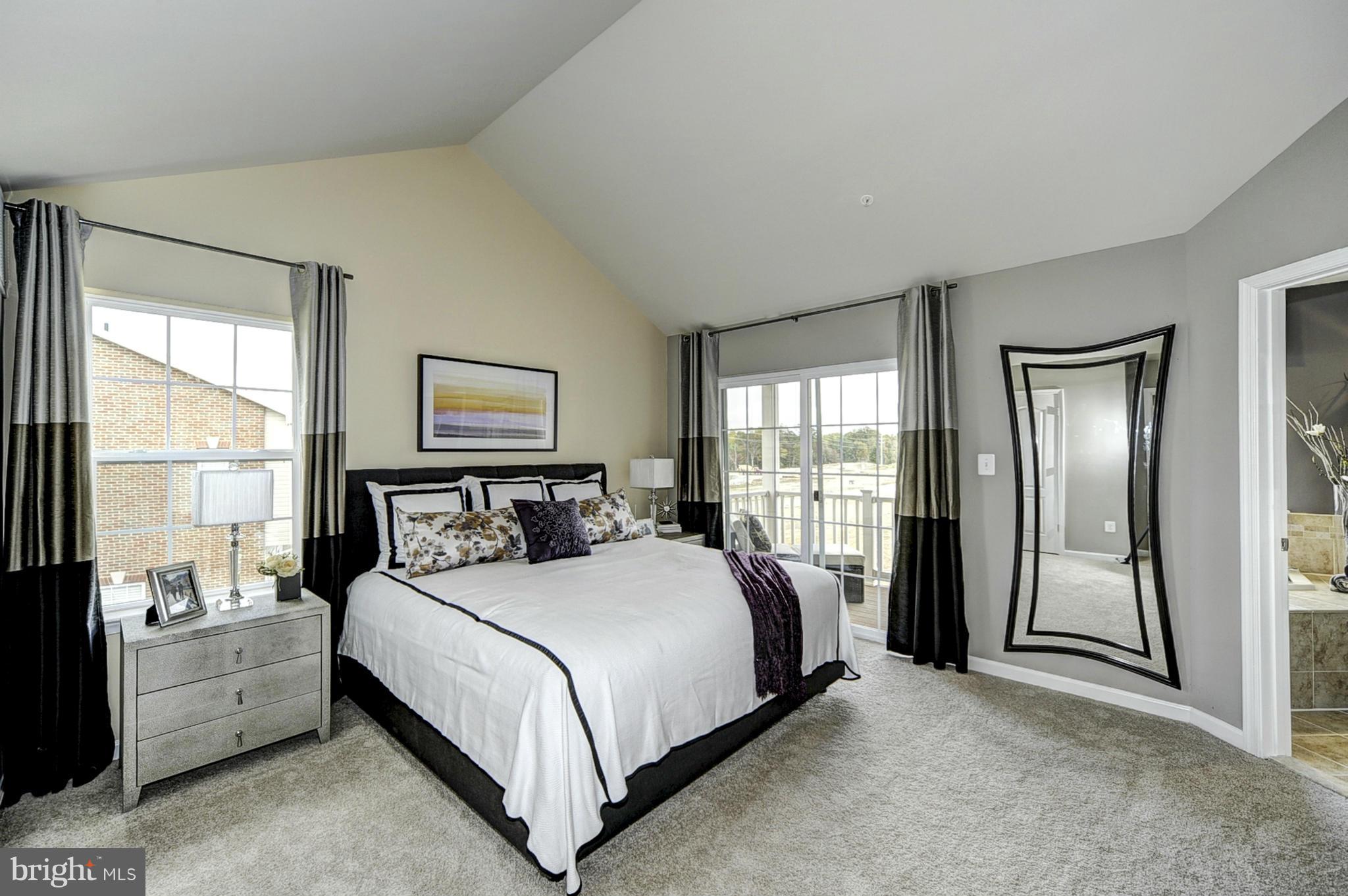 1003 Red Clover Road Gambrills, MD 21054 - Photo 11 of 30 a large bedroom with a large bed and a large window