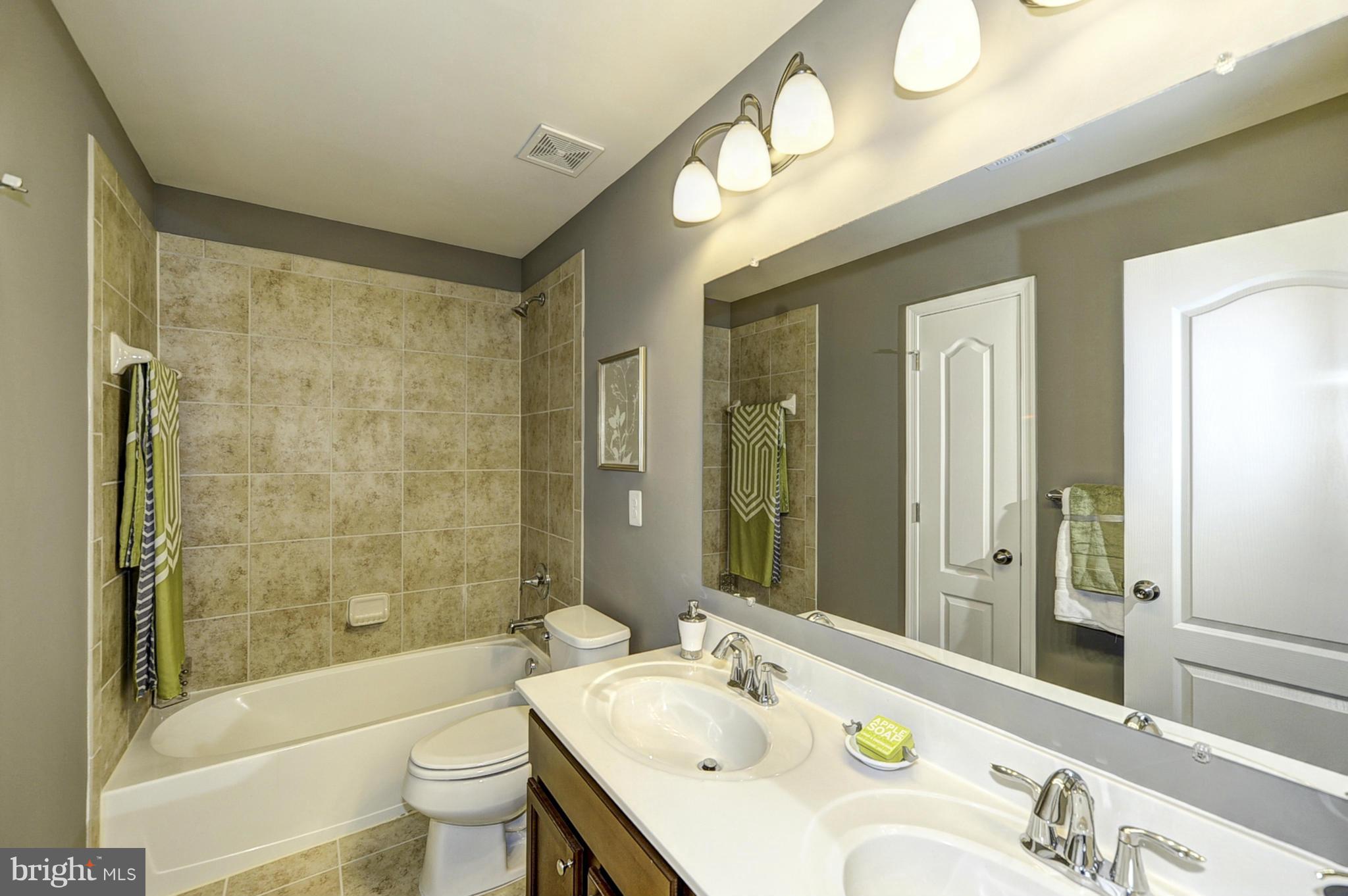 1003 Red Clover Road Gambrills, MD 21054 - Photo 20 of 30 a bathroom with a granite countertop sink mirror toilet and bathtub