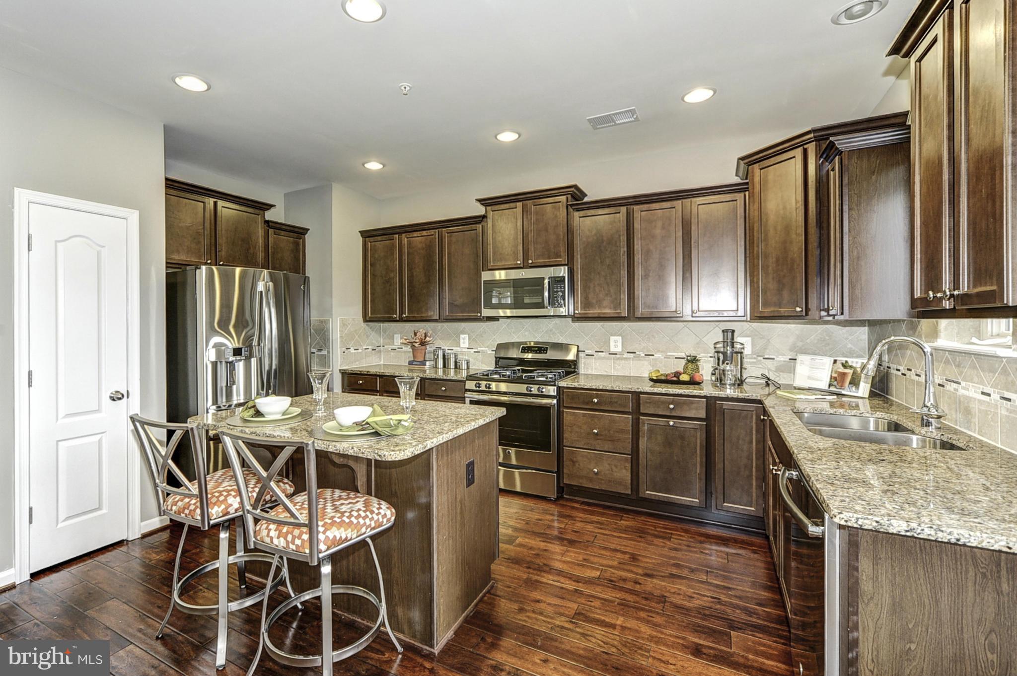 1003 Red Clover Road Gambrills, MD 21054 - Photo 3 of 30 a kitchen with stainless steel appliances granite countertop wooden cabinets a sink stove and refrigerator