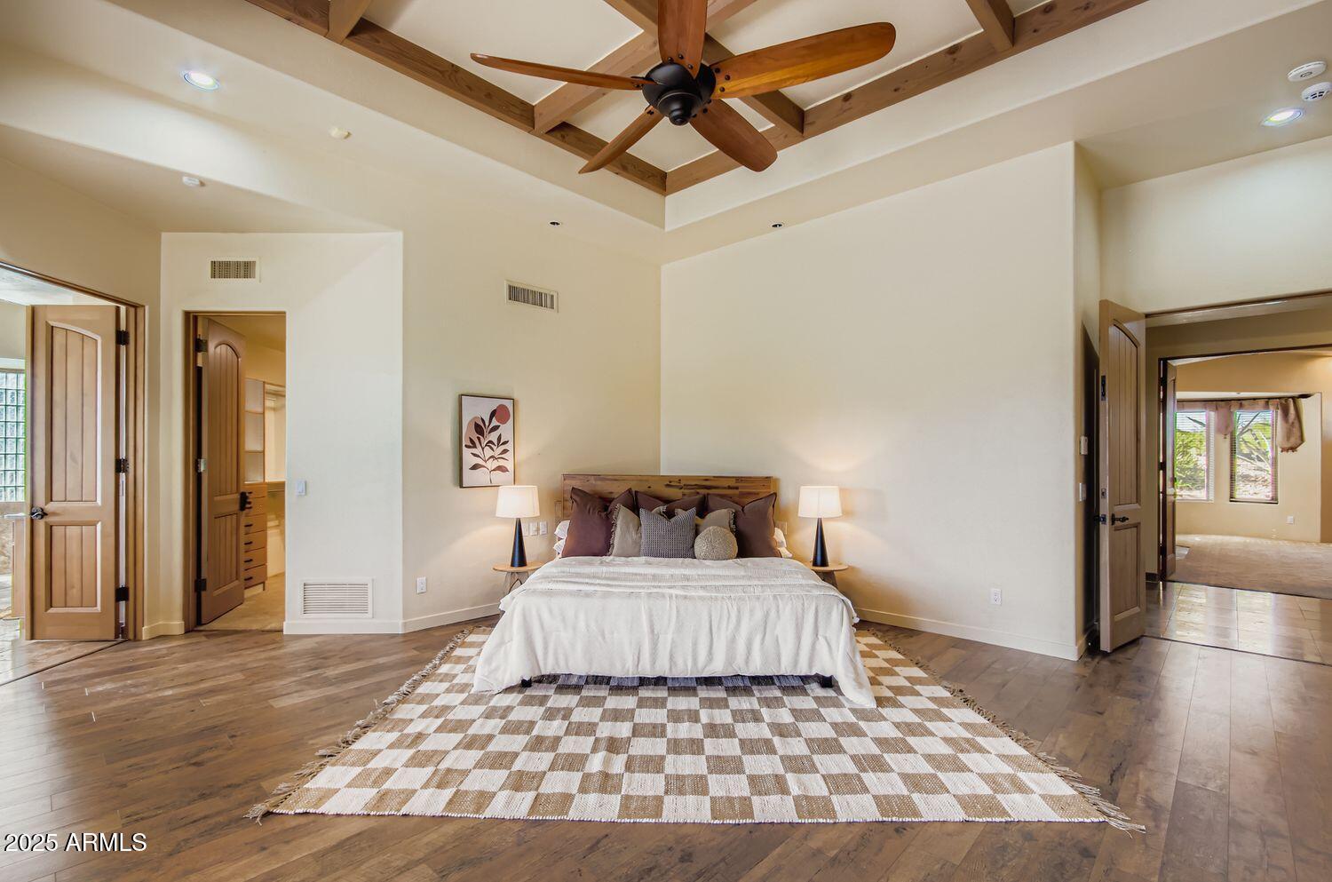 9247 North 24th Way Phoenix, AZ 85028 - Photo 22 of 99 a bedroom with a large bed rug and wooden floor
