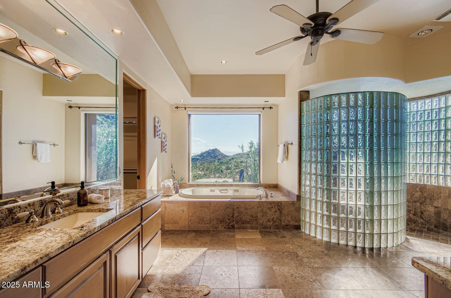 9247 North 24th Way Phoenix, AZ 85028 - Photo 23 of 99 a bathroom with a double vanity sink a mirror and a bathtub