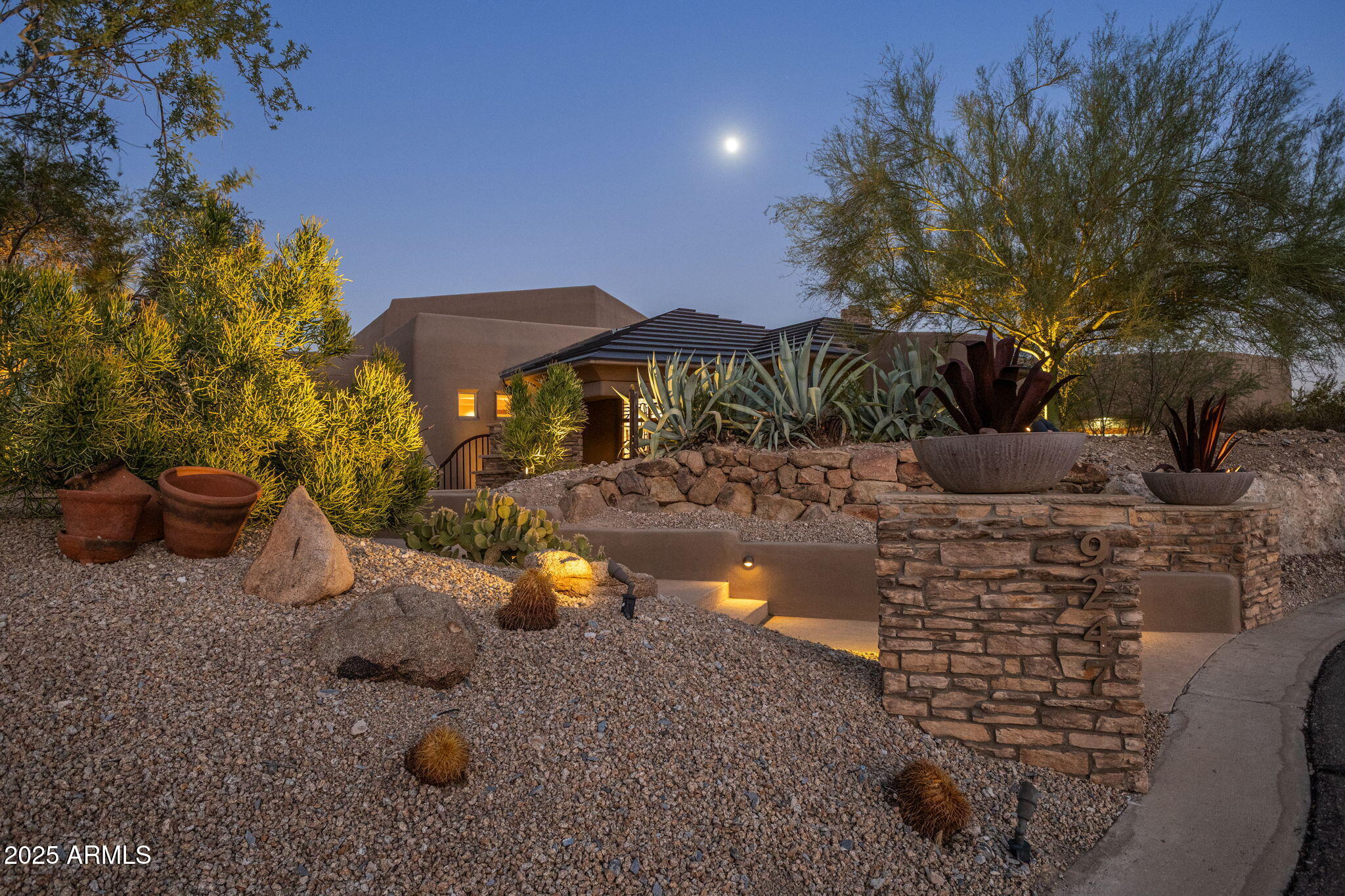 9247 North 24th Way Phoenix, AZ 85028 - Photo 3 of 99 a view of a terrace with chairs and a fire pit