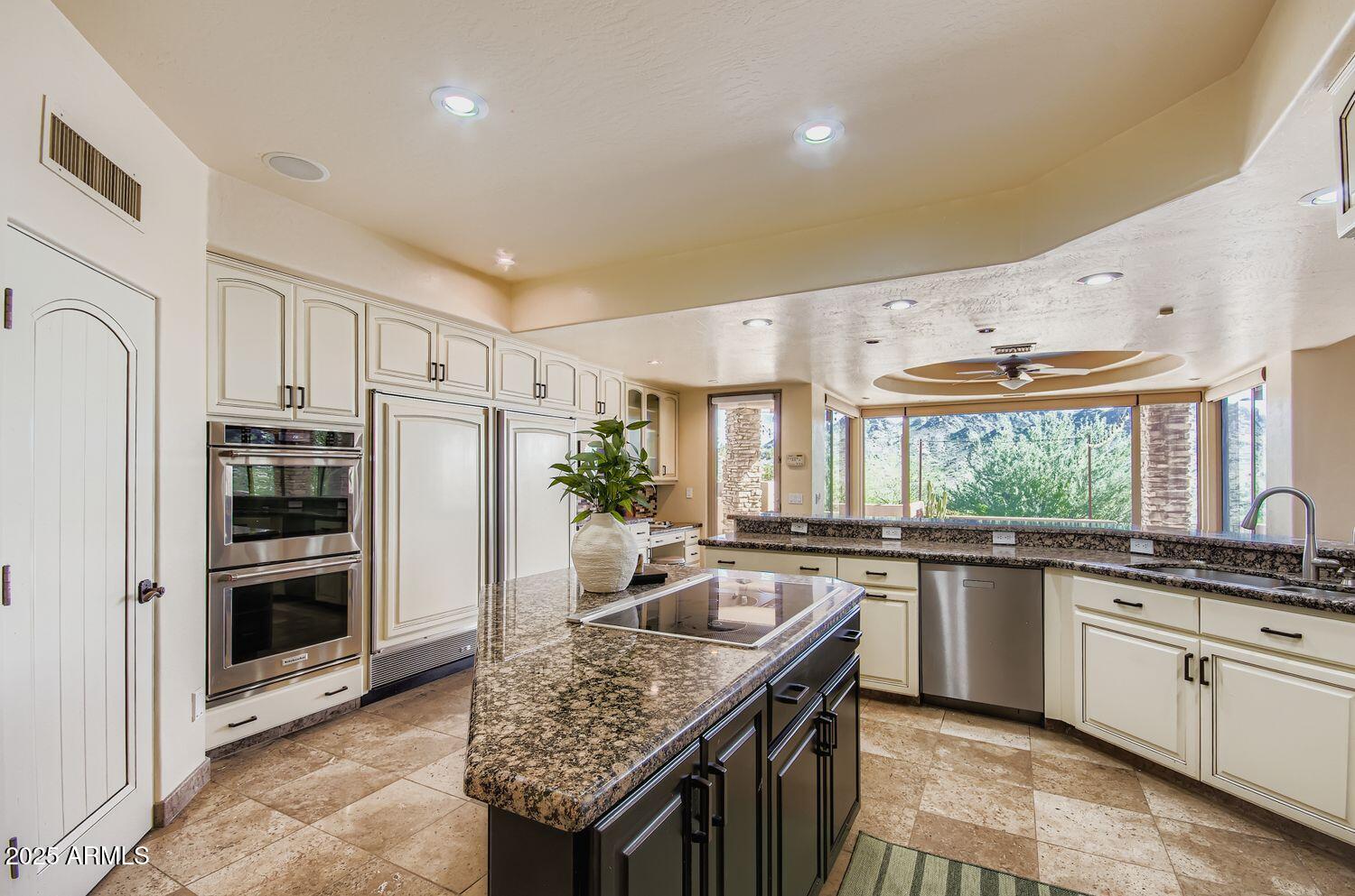 9247 North 24th Way Phoenix, AZ 85028 - Photo 96 of 99 a kitchen with stainless steel appliances granite countertop a sink stove and refrigerator