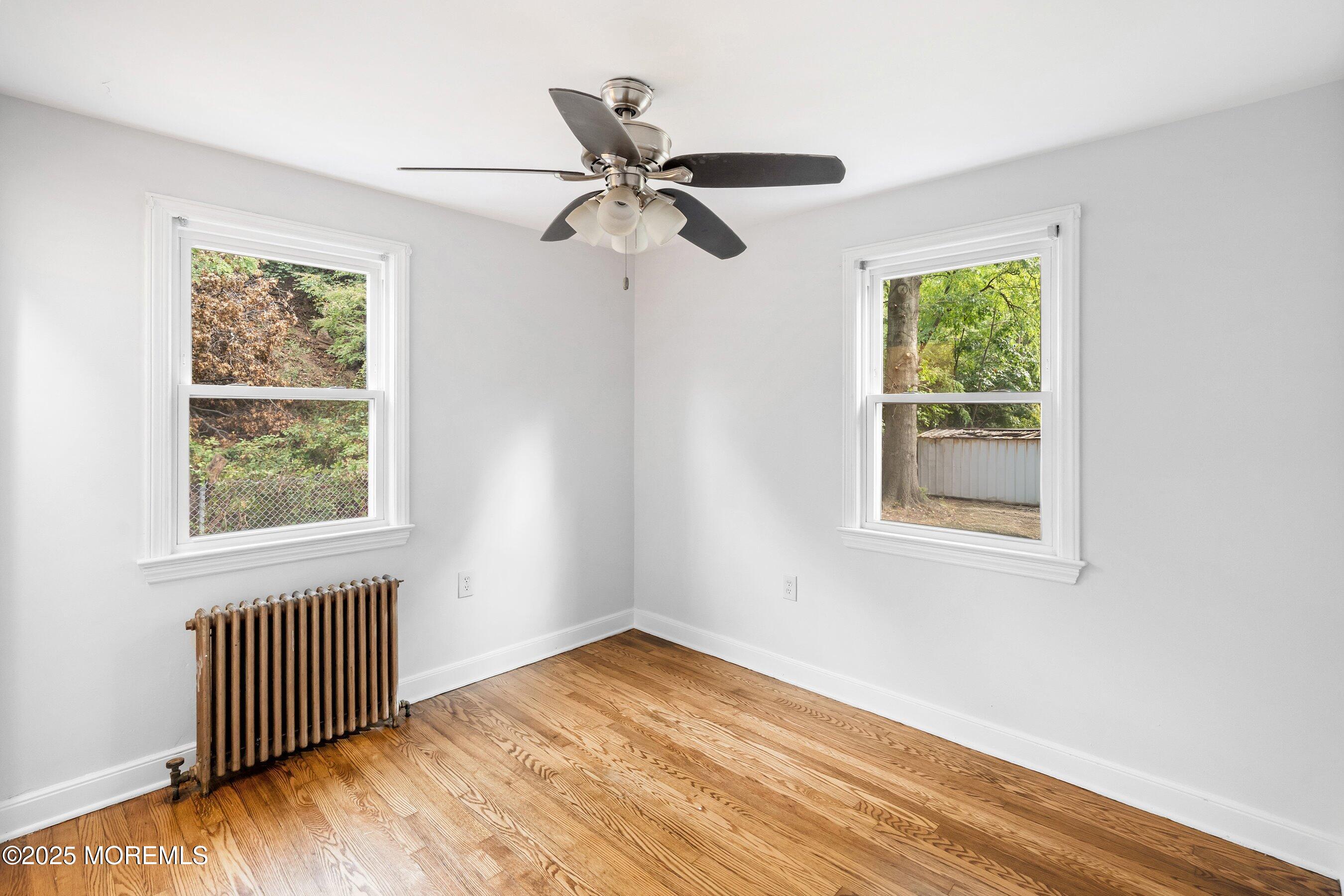 174 Alcoa Avenue Edison, NJ 08837 - Photo 11 of 20 a view of empty room with wooden floor and fan