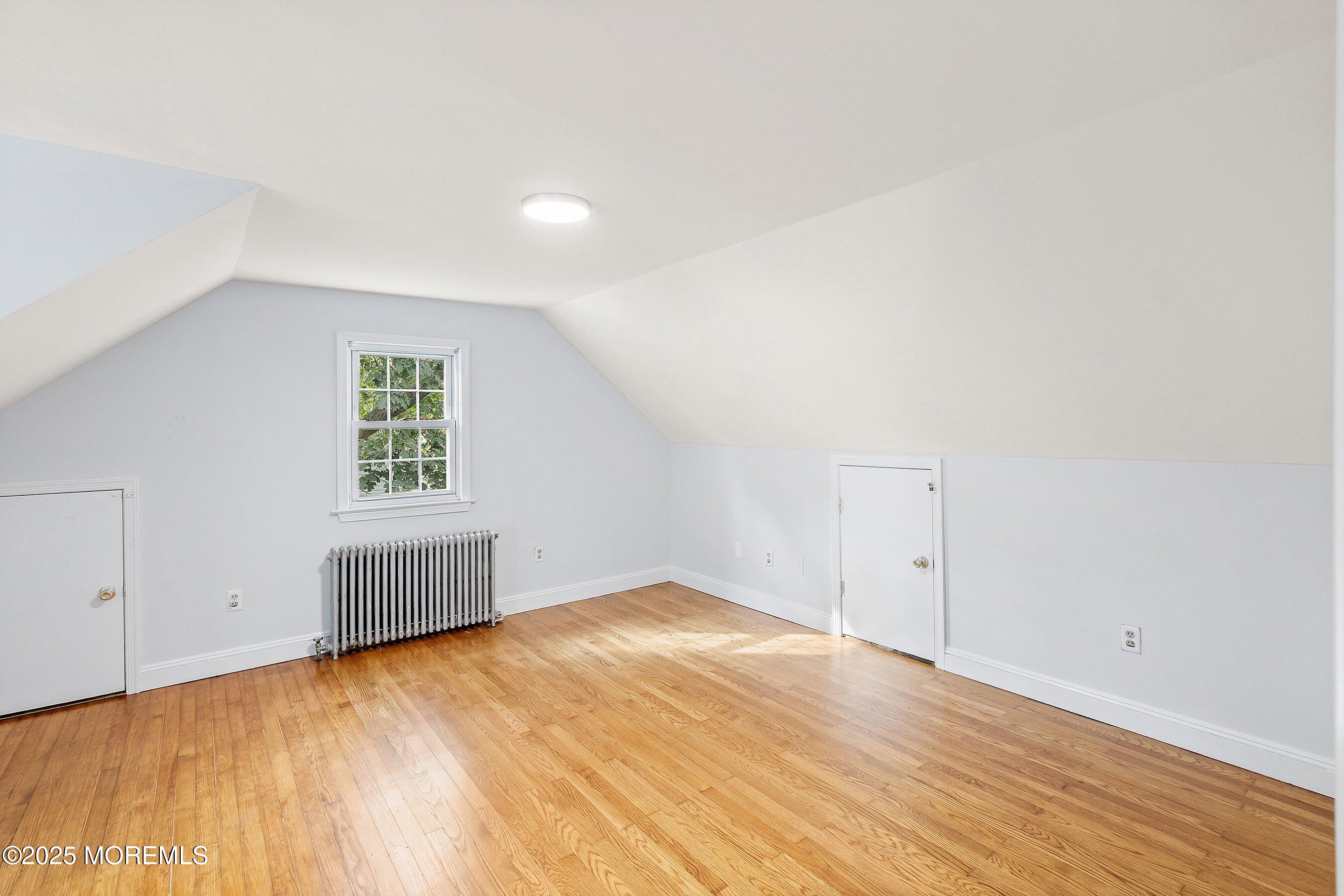 174 Alcoa Avenue Edison, NJ 08837 - Photo 12 of 20 an empty room with wooden floor and windows