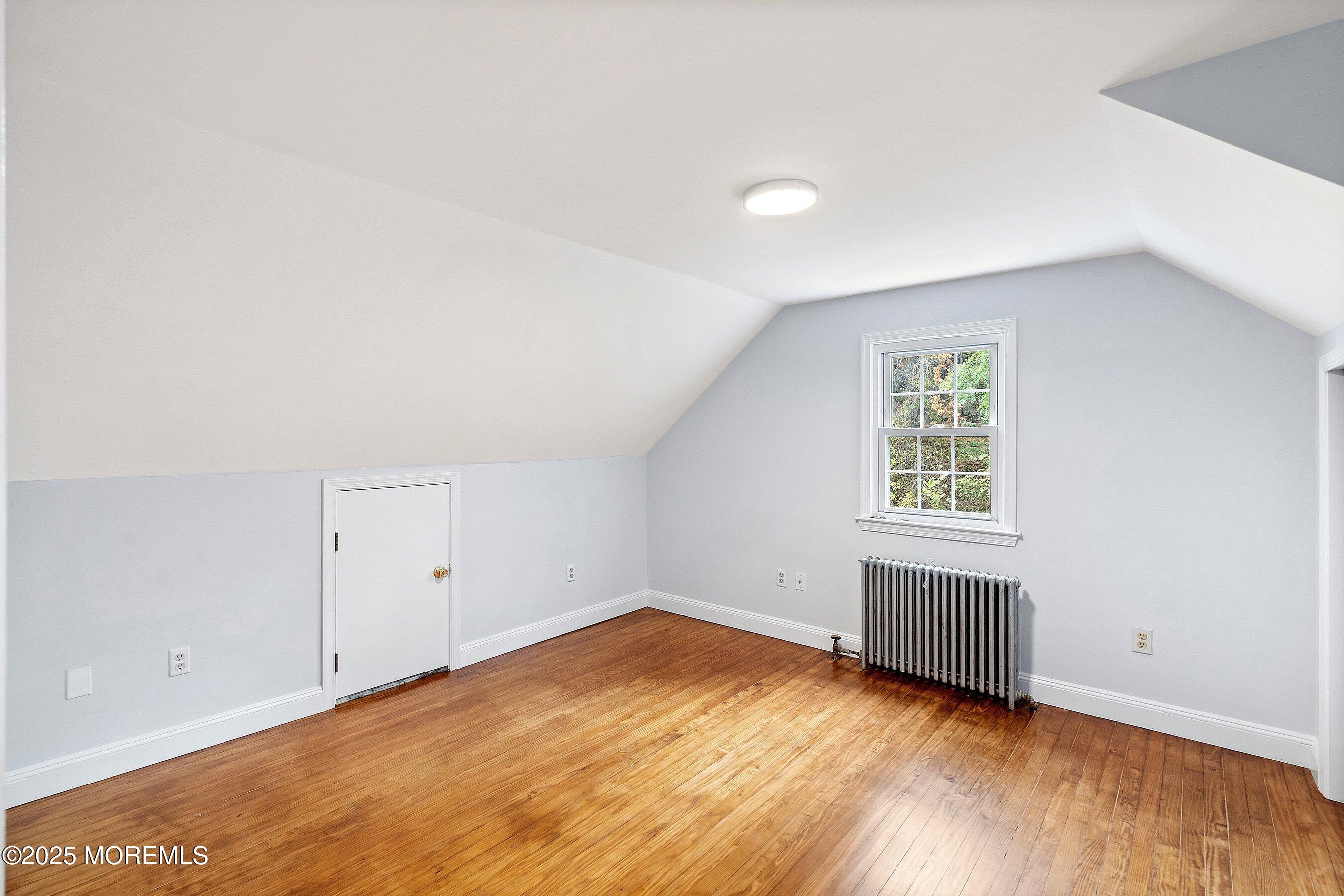 174 Alcoa Avenue Edison, NJ 08837 - Photo 16 of 20 an empty room with wooden floor and windows