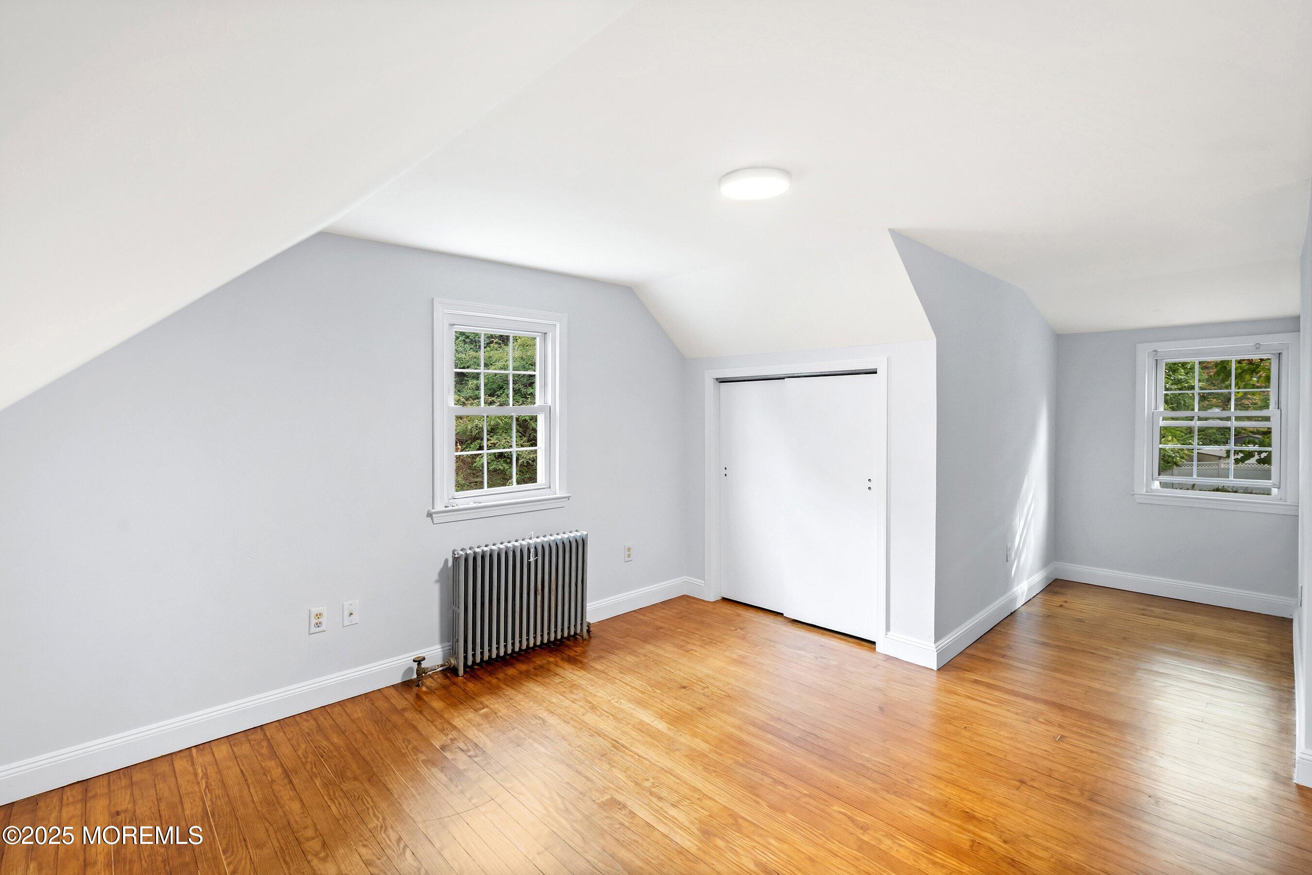 174 Alcoa Avenue Edison, NJ 08837 - Photo 17 of 20 an empty room with wooden floor cabinet and windows