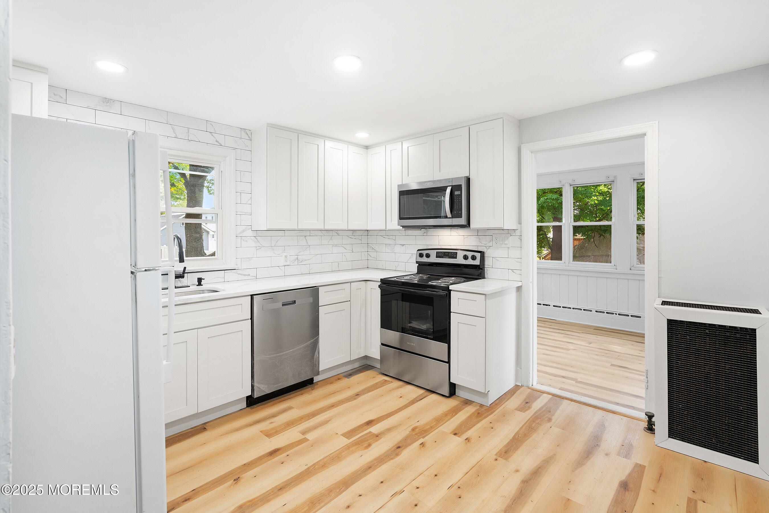174 Alcoa Avenue Edison, NJ 08837 - Photo 5 of 20 a kitchen with a sink stove top oven and refrigerator