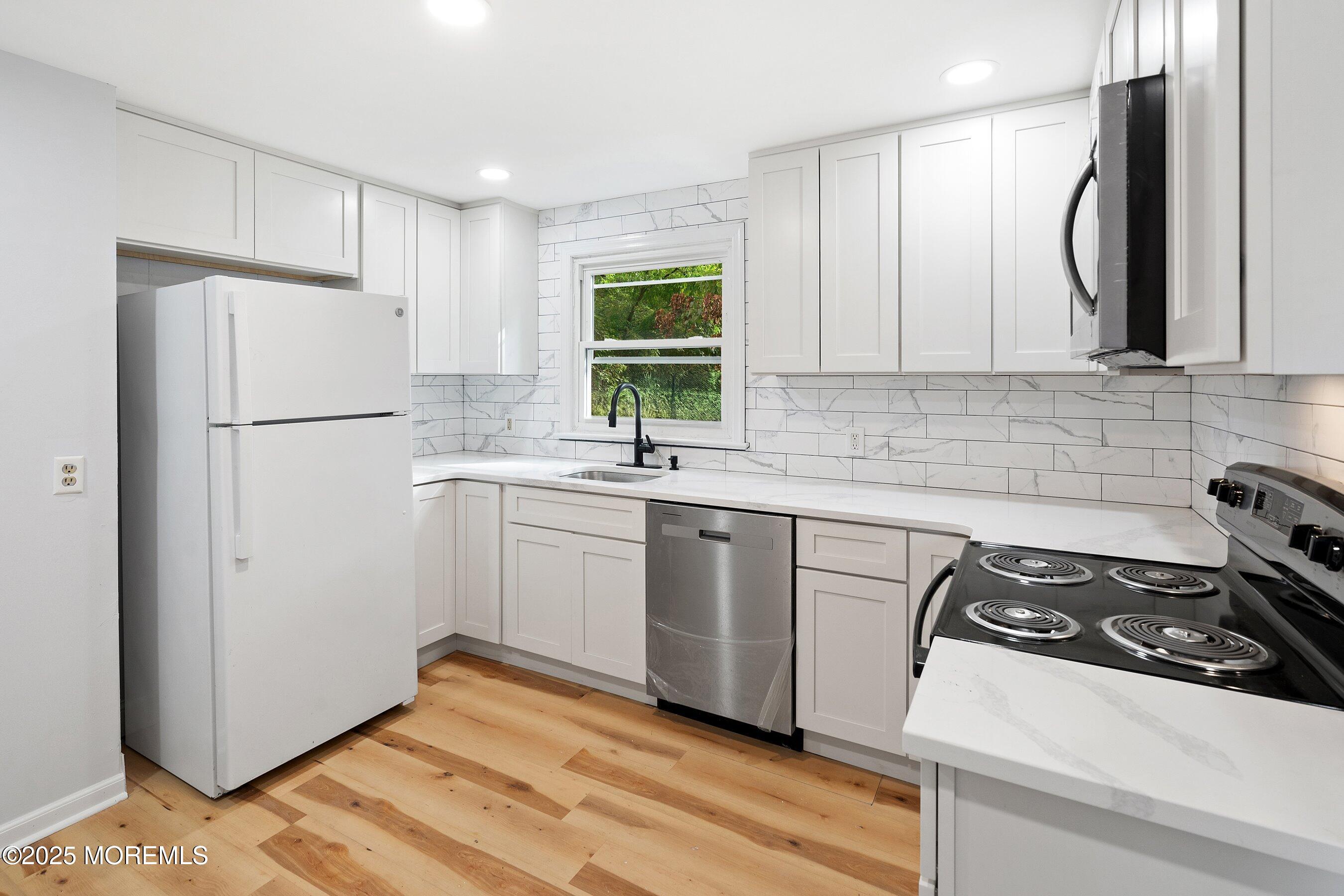 174 Alcoa Avenue Edison, NJ 08837 - Photo 6 of 20 a kitchen with a white cabinets and a refrigerator