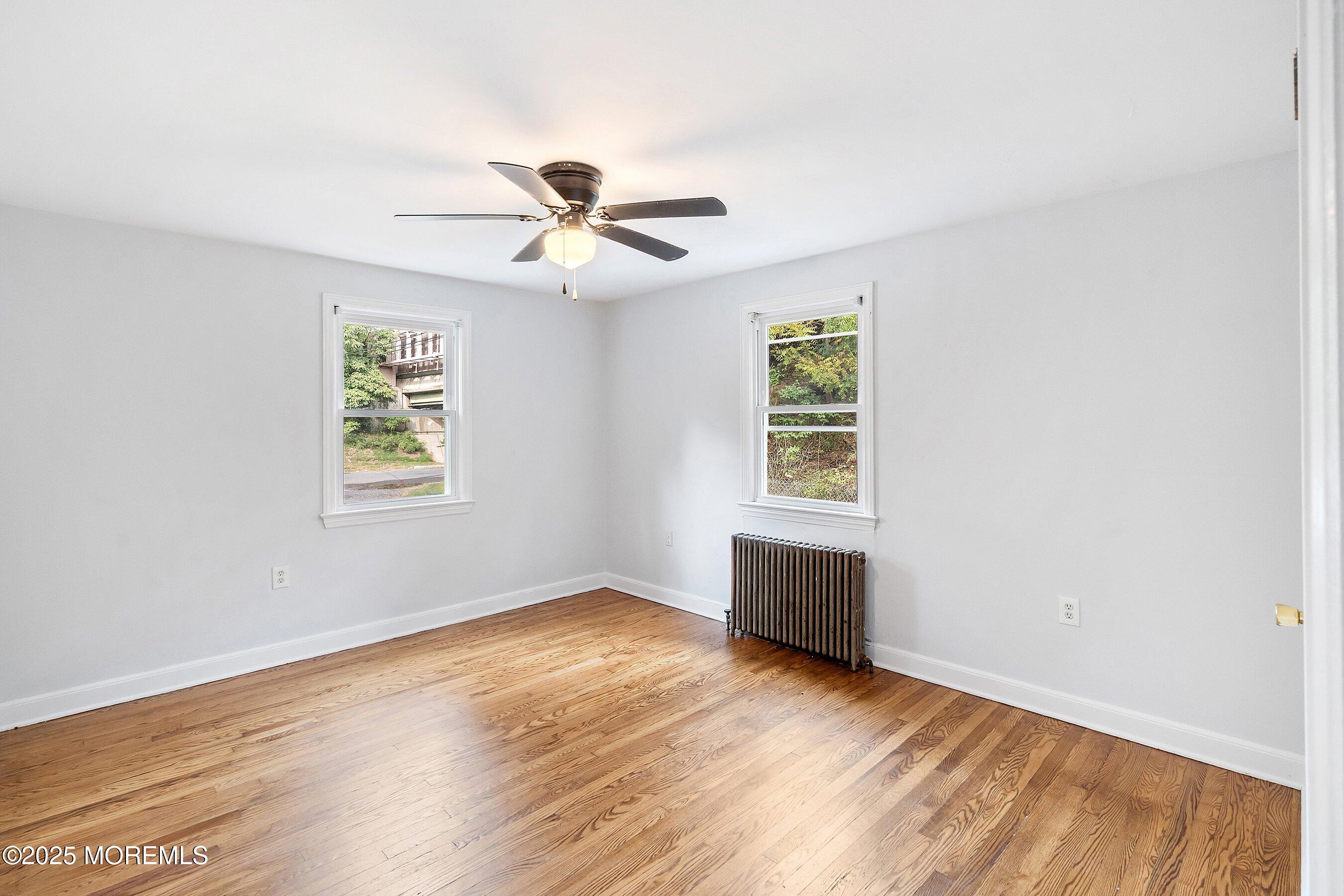 174 Alcoa Avenue Edison, NJ 08837 - Photo 10 of 20 a view of empty room with wooden floor and fan
