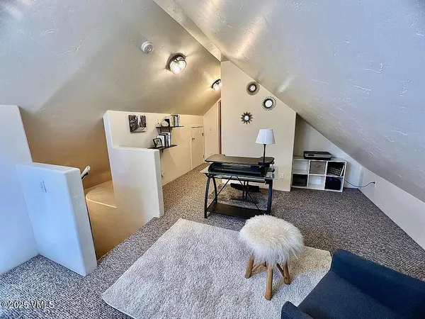 a living room with furniture and a piano
