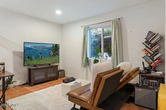 a bedroom with furniture and a window