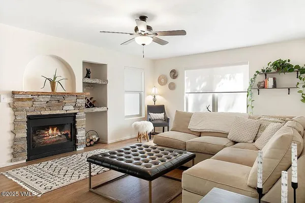 a living room with furniture a rug and a fireplace
