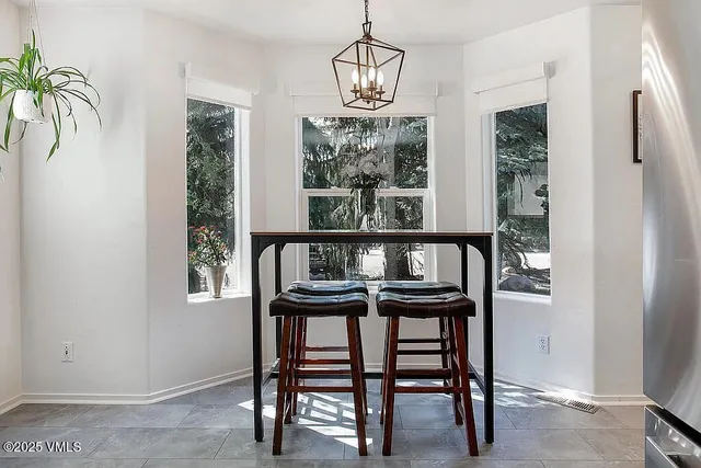 a view of a dining room with furniture window and outside view