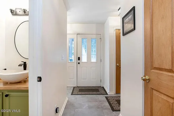 a view of a hallway with wooden floor and entryway