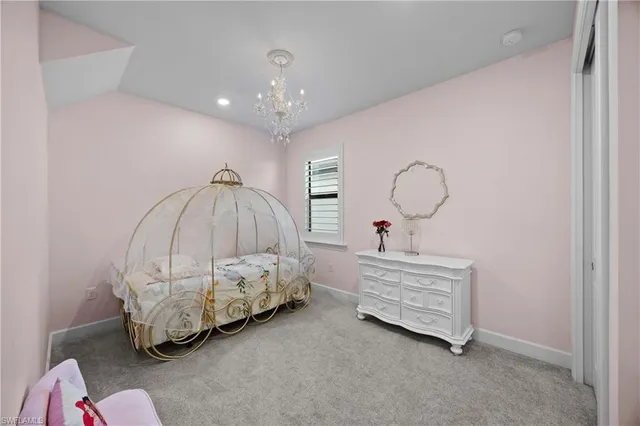 a bedroom with a bed mirror and couch